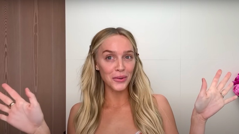 Alex Cooper demonstrating her skincare routine