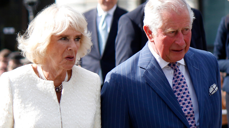 Camilla and Prince Charles hold hands