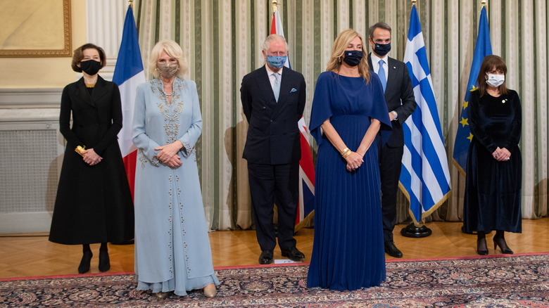 Camilla, Queen Consort poses in face mask with other officials