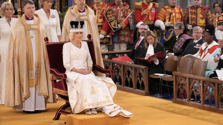 Camilla, Queen Consort sits on throne in Westminster Abbey