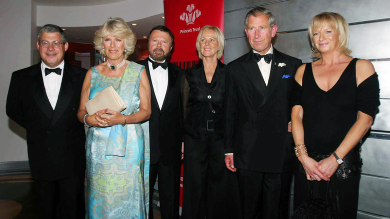 Camilla, Queen Consort smiles with King Charles III and friends.