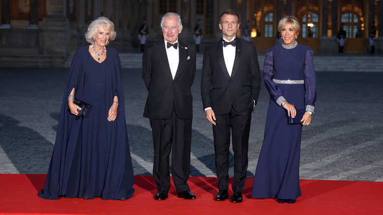 Camilla, Queen Consort smiles with King Charles III, Emmanuel and Brigitte Macron