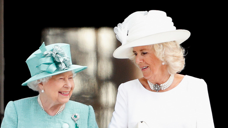 Camilla and Queen Elizabeth looking at each other 