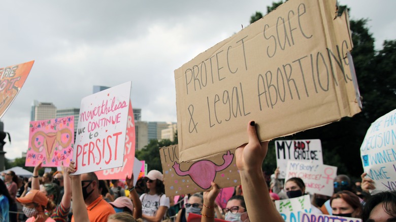 pro-abortion protestors holding signs and marching