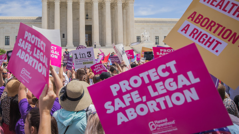 pro-abortion protestors holding signs and marching