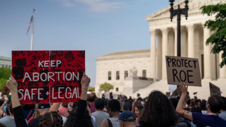 pro-abortion protestors holding signs and marching