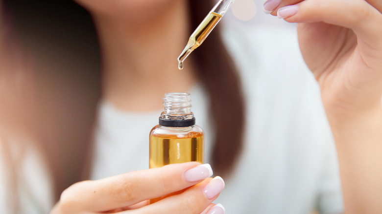 Woman holding hair oil