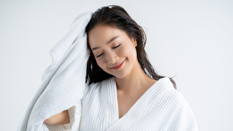 Woman drying her hair after a shower