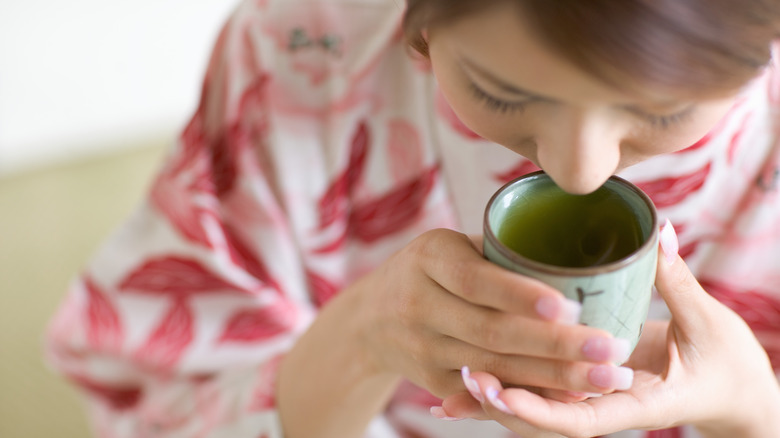 Woman drinking green tea