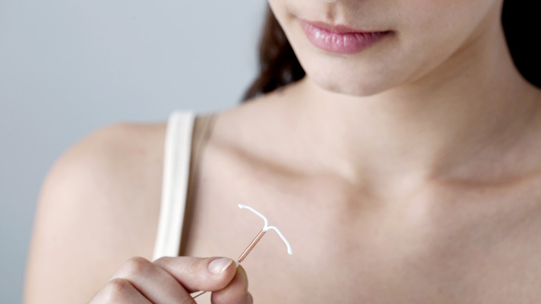 woman holding iud