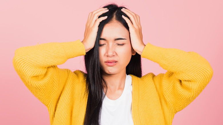 Tired woman holding head