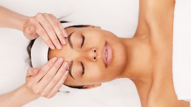 woman relaxes while receiving facial