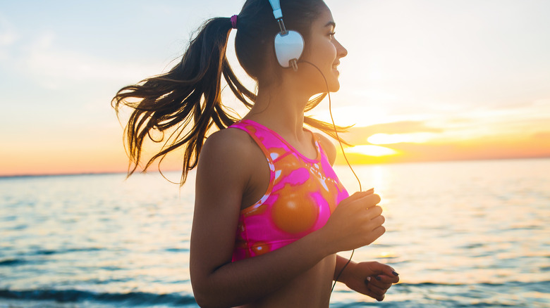 A woman listening to music while running 