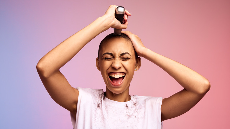 Woman shaving her head