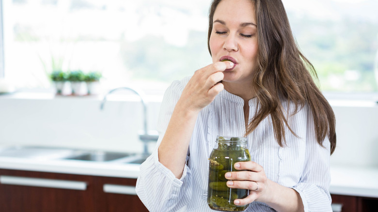 Woman eating pickles