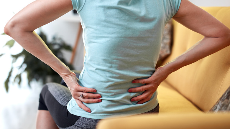 Woman with back and hip pain due to tight hip flexors