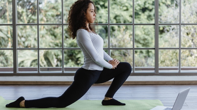 Fit woman stretching her hip flexors
