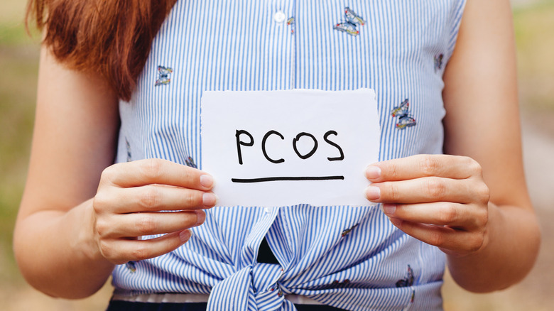 woman holding pcos sign