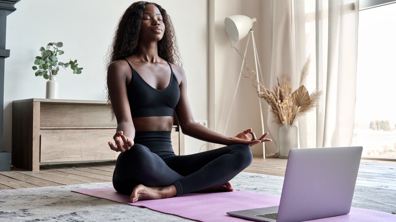 woman meditating practicing yoga