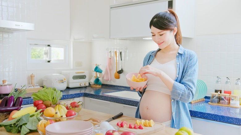 pregnant woman eating fruit 