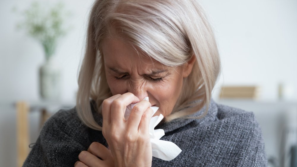 Woman sneezing