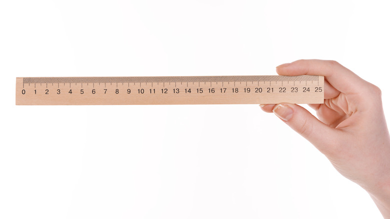 Woman holding ruler 