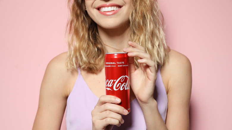 Woman holding soda can