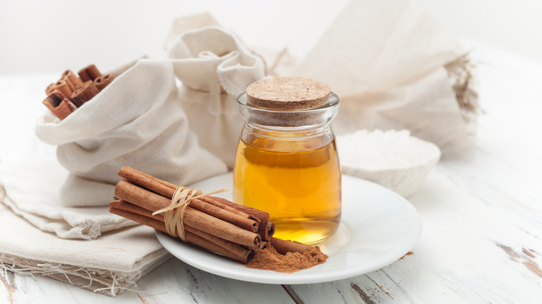 cinnamon sticks and honey jar