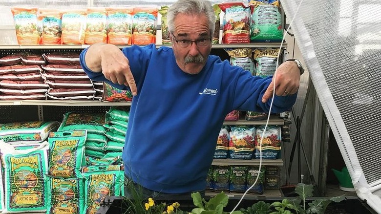 Paul James pointing at plants