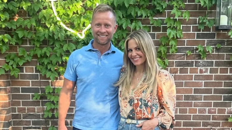 Candace Cameron Bure smiling with husband Valeri Bure outside