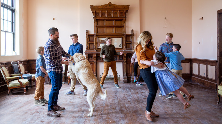 Meredith family and dog in living room