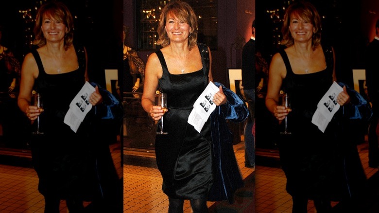 Carole Middleton rocks a little black dress and holds a glass of champagne