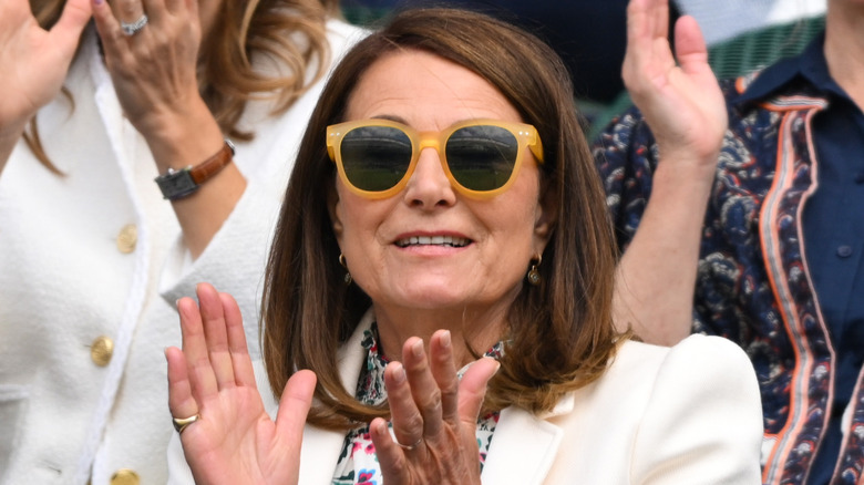 Carole Middleton claps while wearing sunglasses