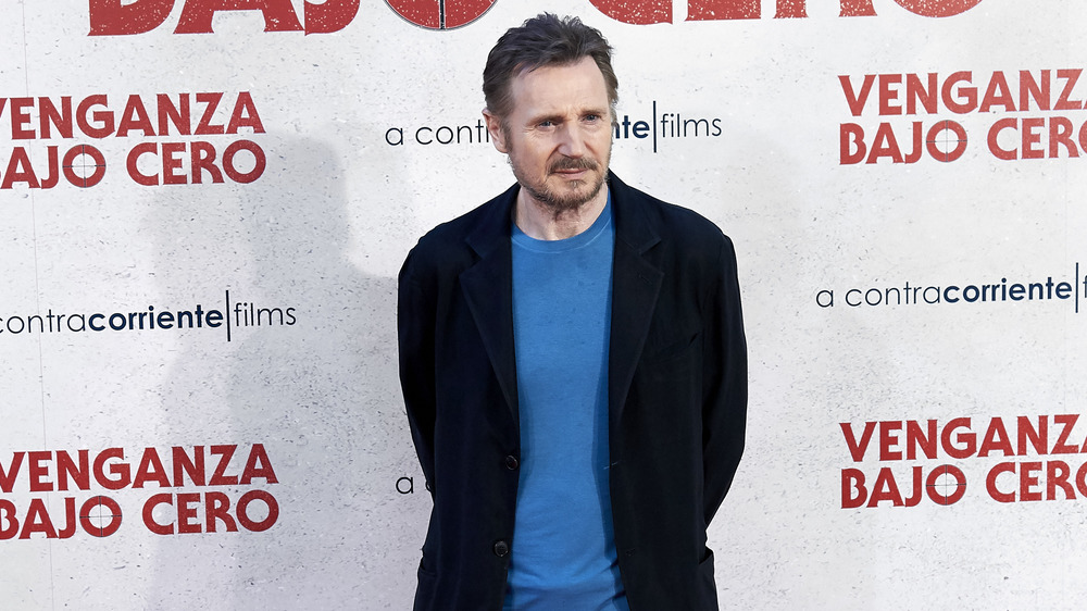 Liam Neeson in blue shirt