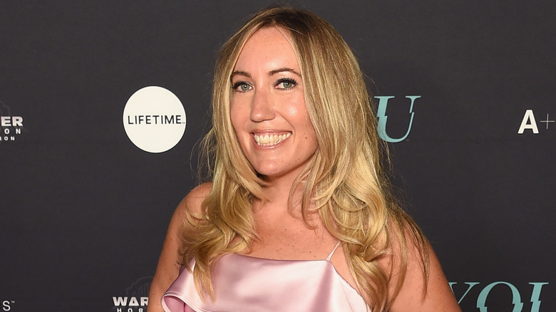 Caroline Kepnes smiling in pink dress