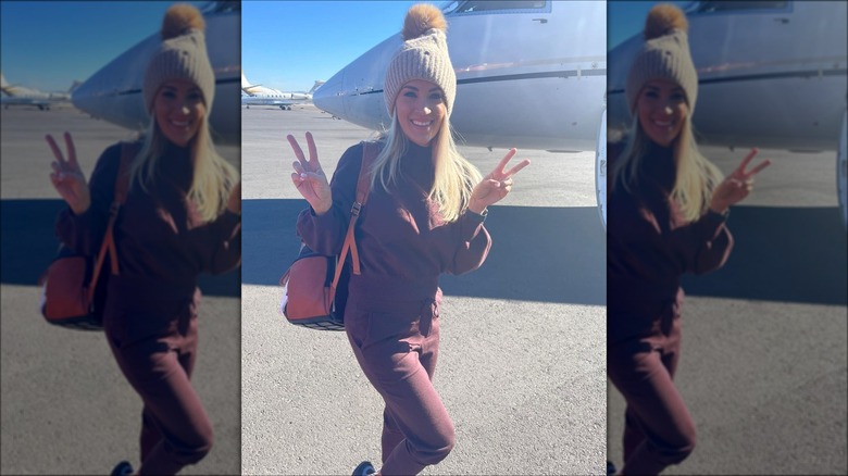 Carrie Underwood in front of a plane