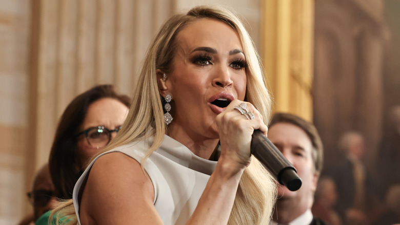 Carrie Underwood singing into microphone