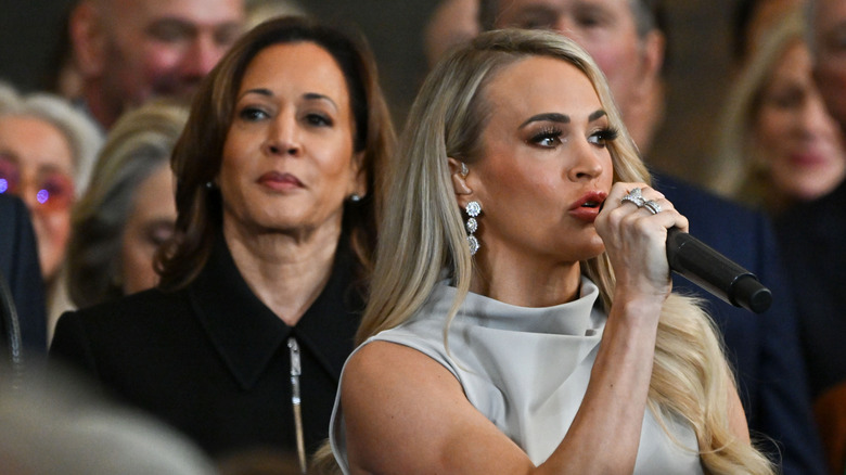 Kamala Harris looking unimpressed as Carrie Underwood signs 