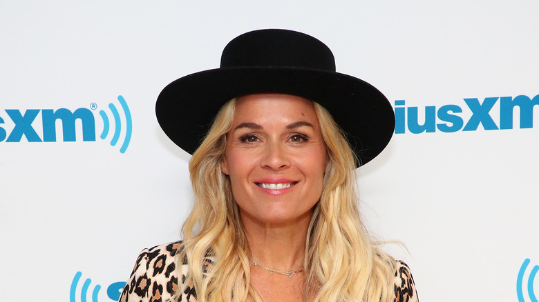 Cat Cora in black hat