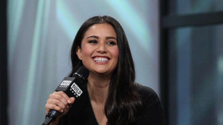 Catherine Giudici talking into a microphone and smiling