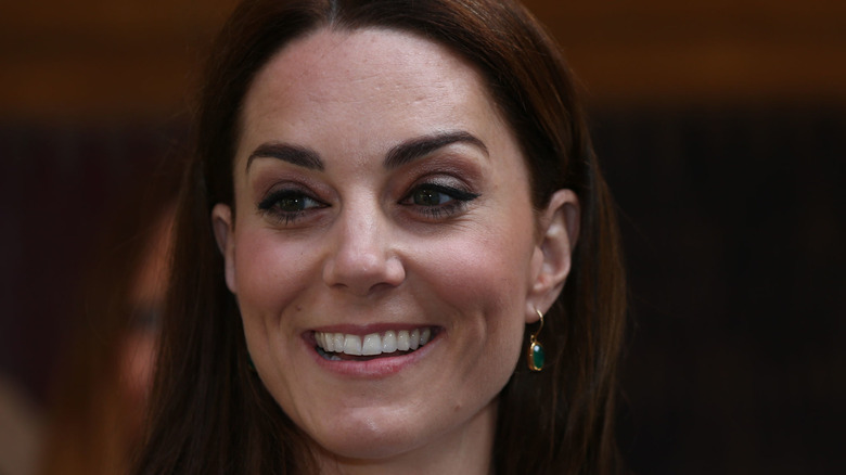 Kate Middleton smiling with Monica Vinader drop earrings