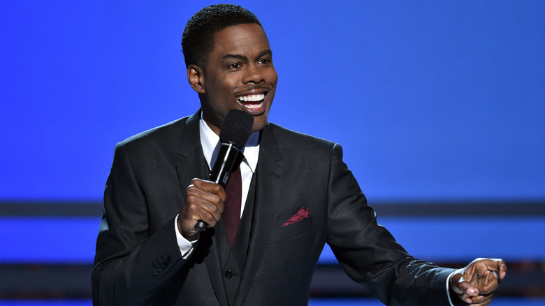 Chris Rock talking into a microphone 
