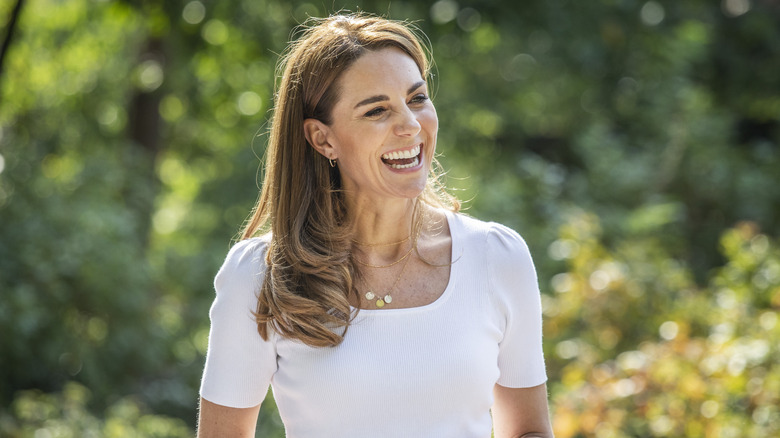 Catherine Middleton smiling in a white top