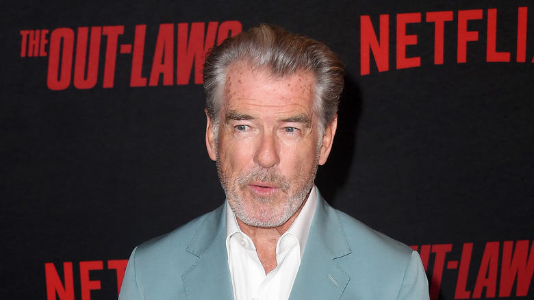 Pierce Brosnan posing at event