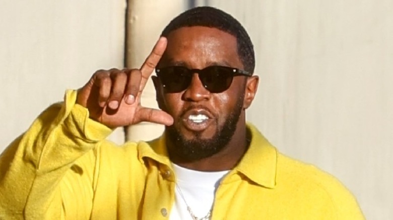 Sean Diddy Combs making an L with his hand