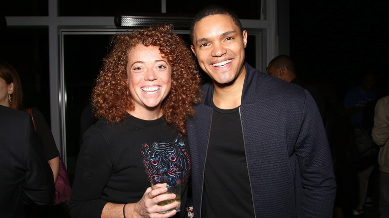 Trevor Noah and Michelle Wolf smiling