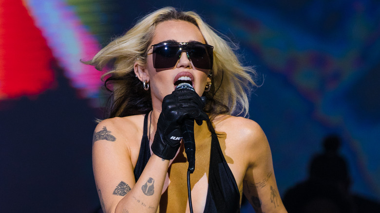 Miley Cyrus performing in dark glasses 