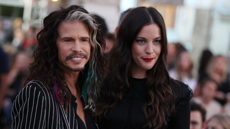 Steven Tyler and Liv Tyler smile together at an event