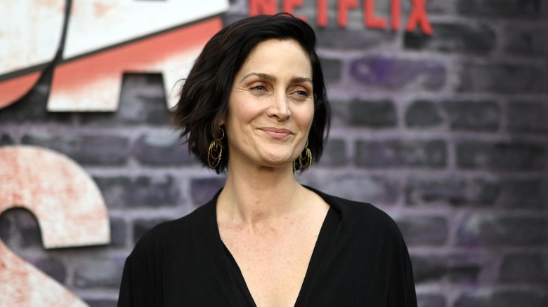 Carrie Anne Moss poses at an event