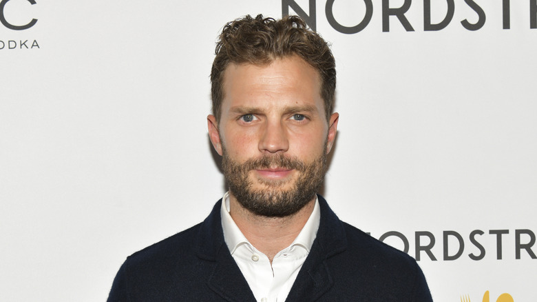 Jamie Dornan poses at an event